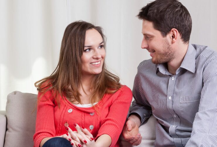 Couple communicating on a couch